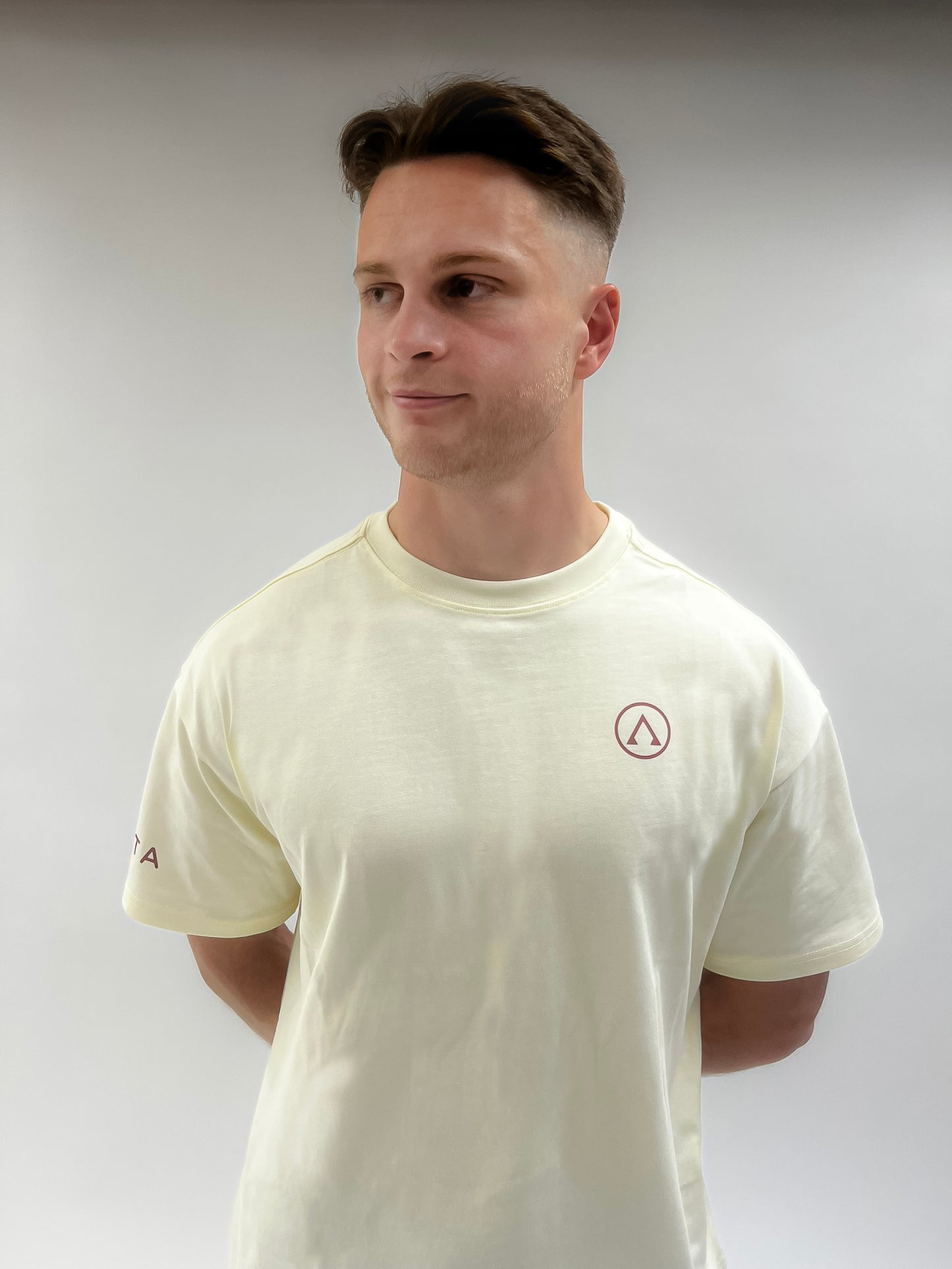 Front of the Invicta Crimson Oversized Gym T-Shirt in beige, made from premium 285GSM cotton.